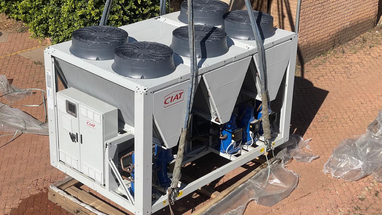 New air-cooled chiller delivered and rigged for installation.