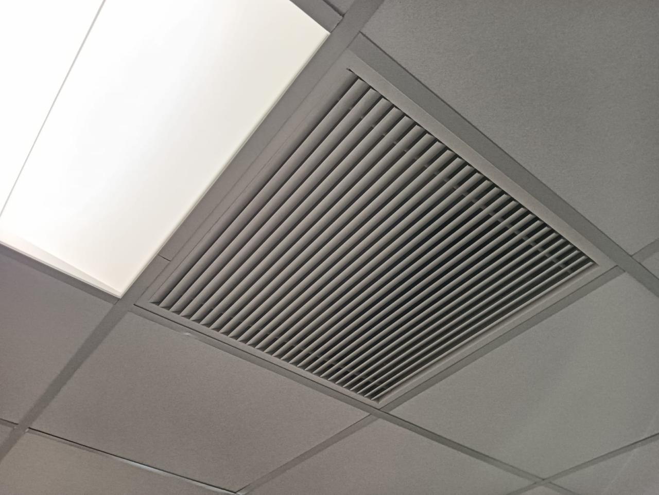 Supply air diffuser installed in an office ceiling.